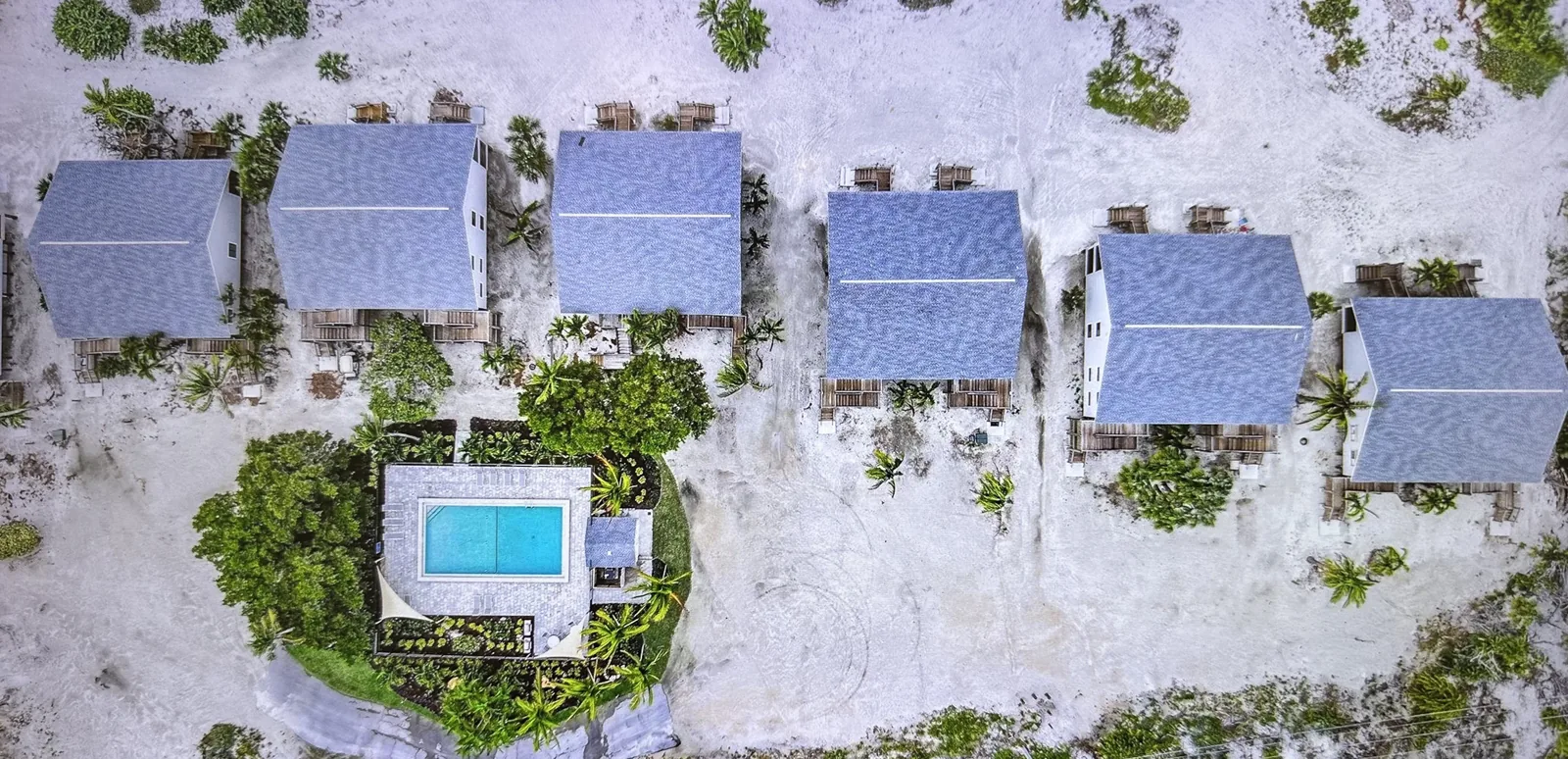 Beachfront cottages along the white sand and turquoise Gulf waters of Captiva Island