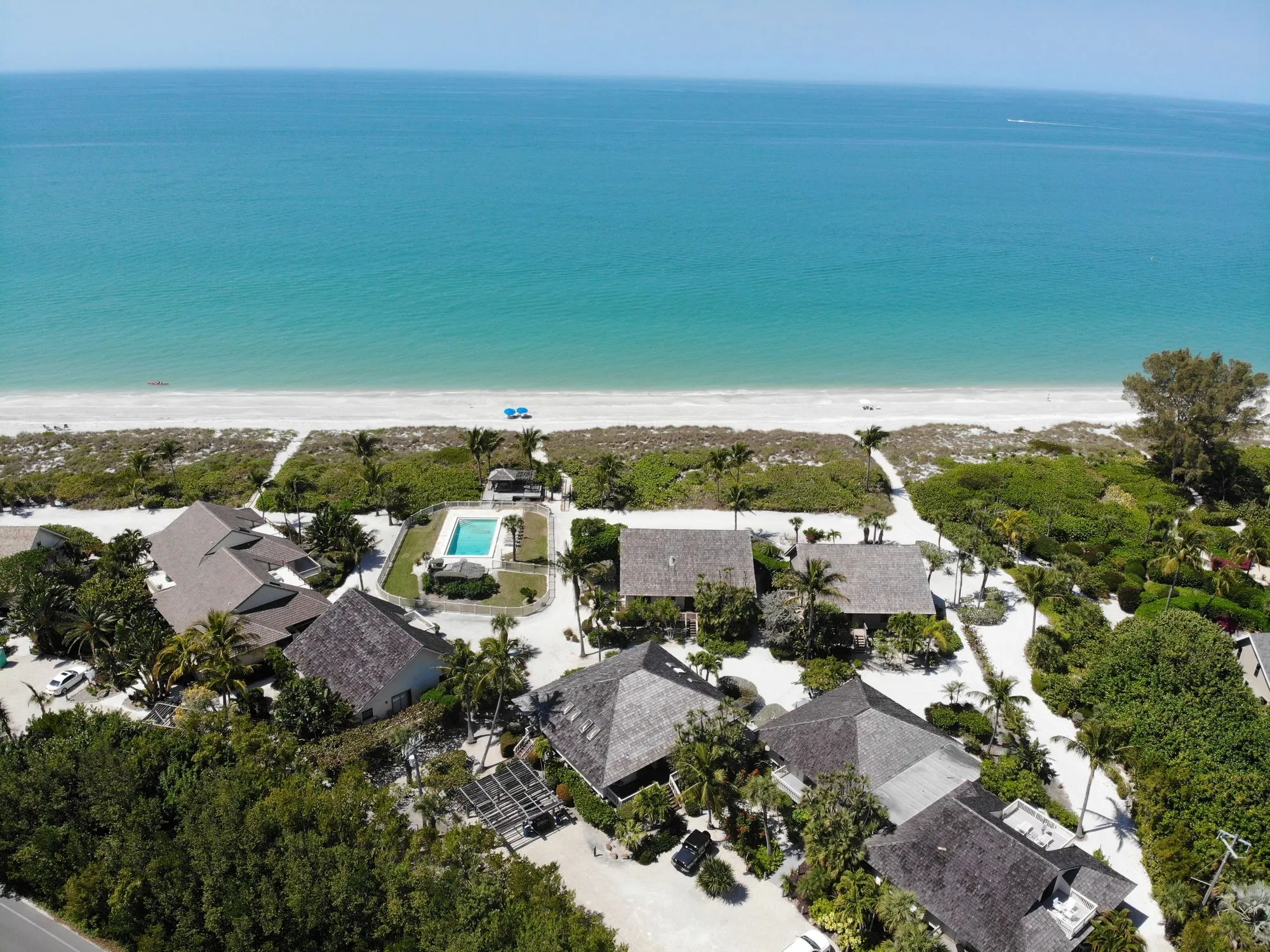 Beachfront cottages along the white sand and turquoise Gulf waters of Captiva Island